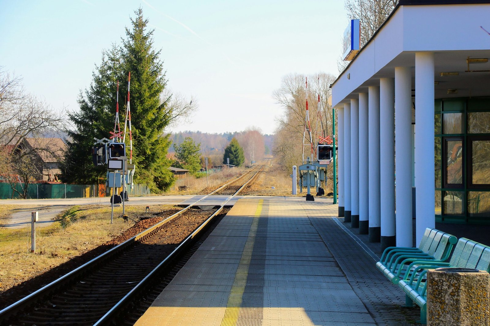 A bench sitting on the side of a train track