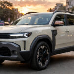 Renault Duster Strong Hybrid SUV on an Indian street at sunset.