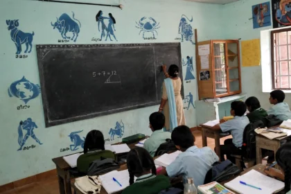 Teacher teaching students in a government school classroom in India