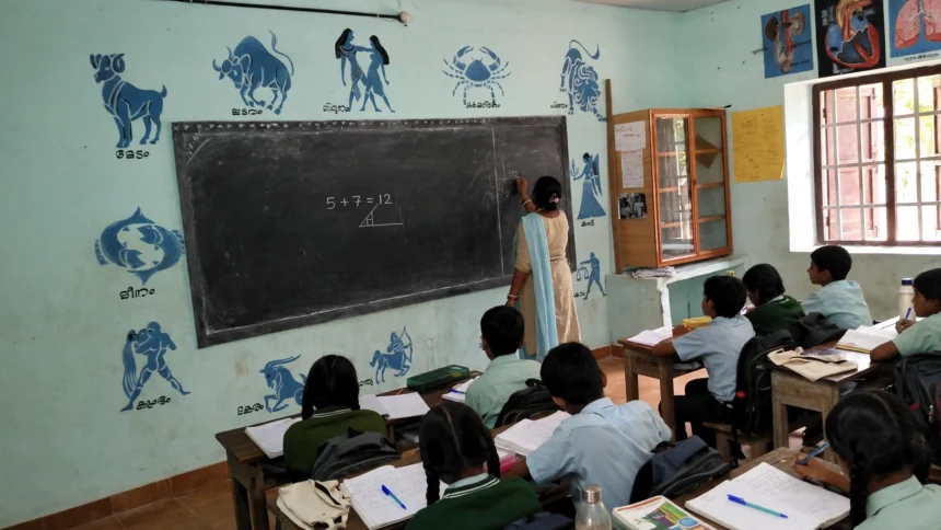 Teacher teaching students in a government school classroom in India