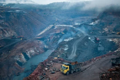 Open-cast coal mine in Jharia, Jharkhand. AI-generated image grounded in a real photo by International Accountability Project / Wikimedia Commons (CC BY 2.0).