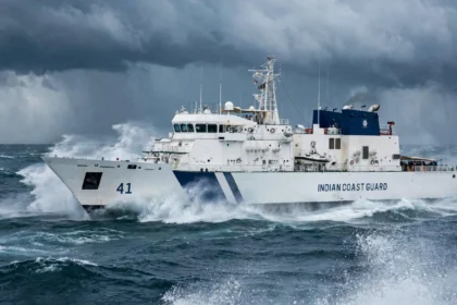 An Indian Coast Guard ship at sea. Photo: BellaNYork / Wikimedia Commons (CC0), background composite.