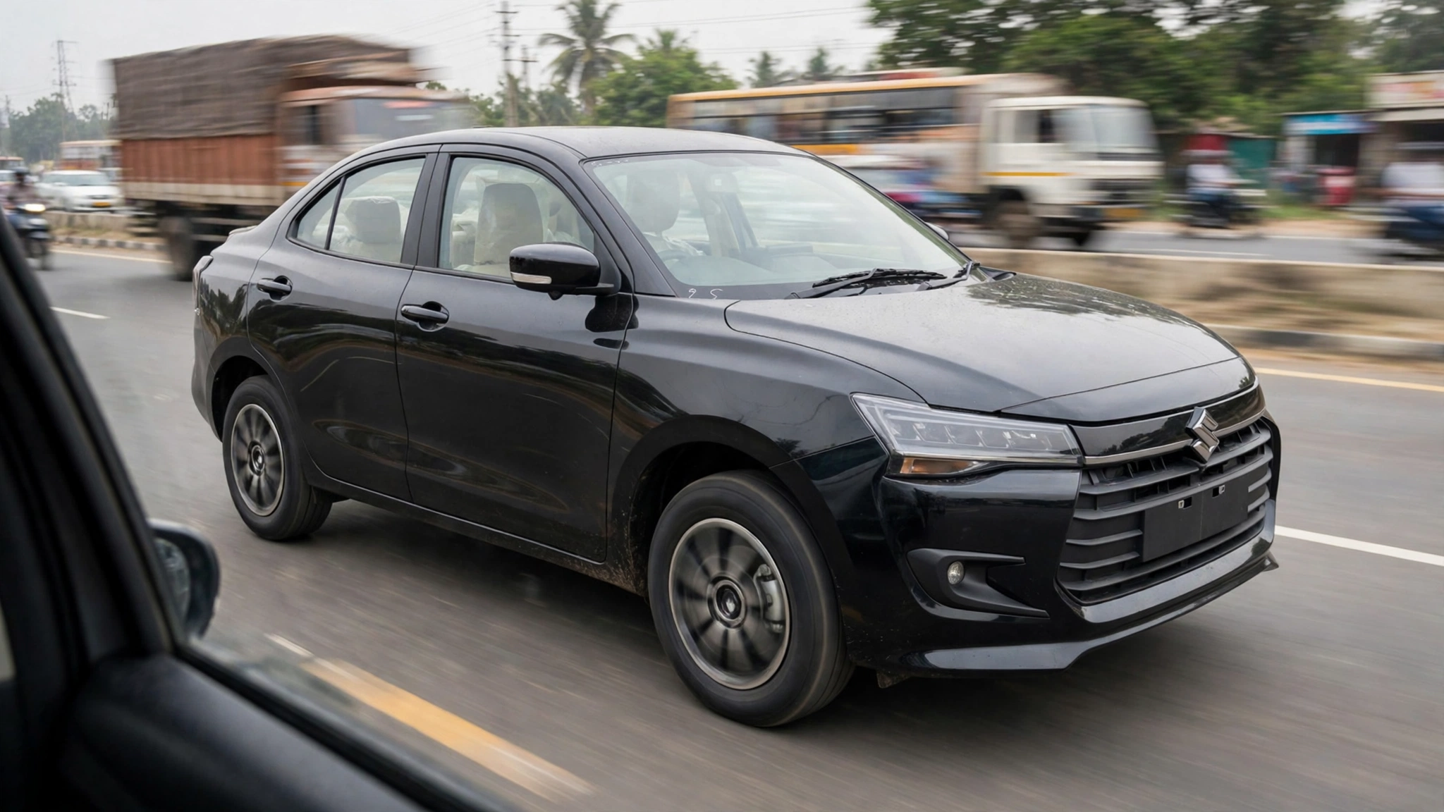 Maruti Suzuki Dzire compact sedan on the road, in a real-world Indian city setting