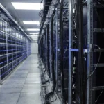 Data centre server room with rows of server racks, illustrative image for Google Gemini 4 Carbon.