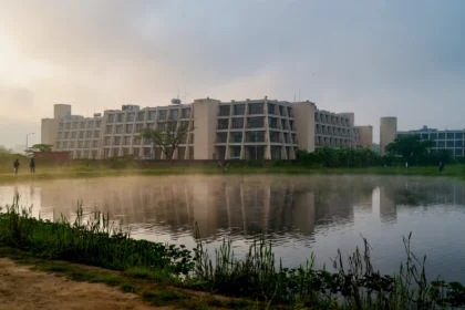 IIM Calcutta campus building beside the lake in Joka, Kolkata. AI-generated image grounded in a real photo by Swayam Soren, CC BY-SA 4.0, via Wikimedia Commons.
