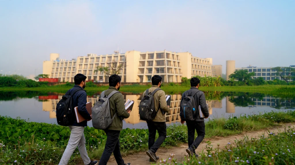 MBA students walking toward the IIM Calcutta campus building beside the lake. AI-generated image grounded in a real photo by Swayam Soren, CC BY-SA 4.0, via Wikimedia Commons.