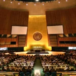 United Nations General Assembly hall in New York. Image generated from a real reference photo (Patrick Gruban / Wikimedia Commons, CC BY-SA 2.0).