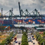 Container ships and cranes at a container terminal, representing India-Mexico trade. Image generated from a real Wikimedia Commons reference photo.