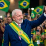 Lula da Silva waves to supporters after winning Brazil's presidential runoff. Photo: Ricardo Stuckert / Wikimedia Commons (background composite).