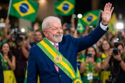 Lula da Silva waves to supporters after winning Brazil's presidential runoff. Photo: Ricardo Stuckert / Wikimedia Commons (background composite).