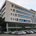 A Maruti Suzuki dealership in India. Reference photo: Wasiul Bahar / Wikimedia Commons (CC BY-SA 4.0); editorial image grounded in the real photo.