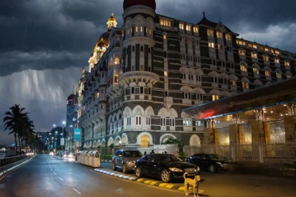The Taj Mahal Palace, Mumbai at night. Base photograph by Mike from Vancouver, Canada via Wikimedia Commons (CC BY-SA 2.0); AI editorial composite.