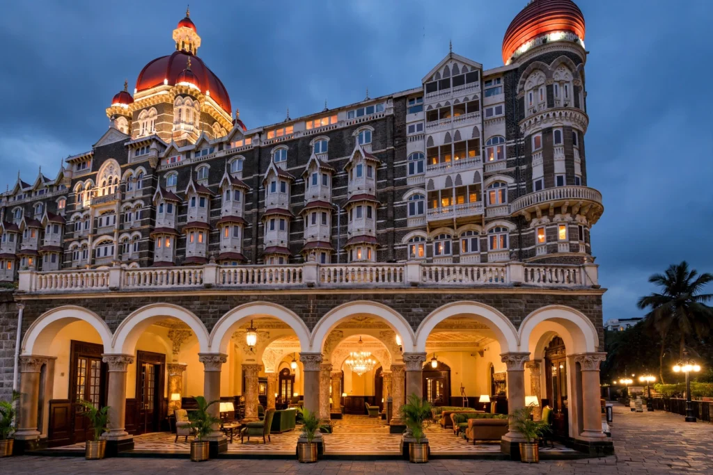 The Taj Mahal Palace, Mumbai at dusk. AI-generated editorial illustration.