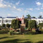 Jamia Millia Islamia campus in Delhi. AI-generated image grounded in a real Wikimedia Commons photo by Wiki1957BOY (CC BY-SA 4.0).