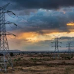 High-voltage transmission towers at dusk