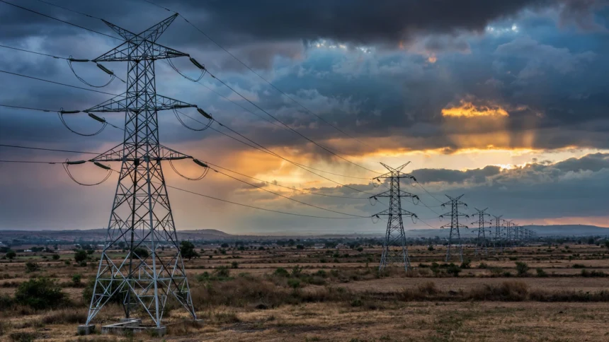 High-voltage transmission towers at dusk
