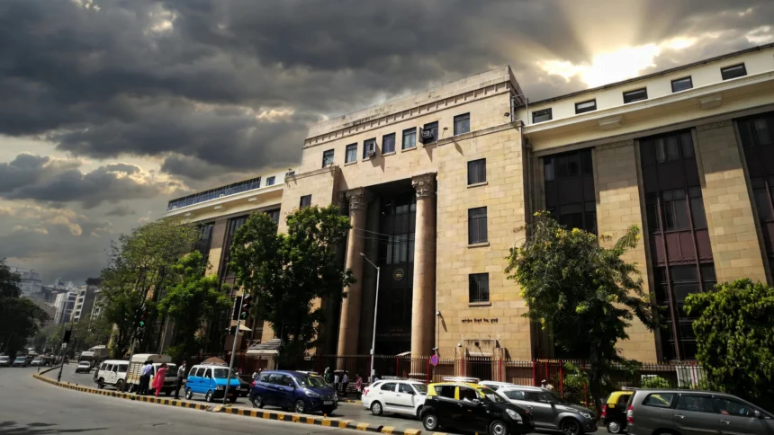 Reserve Bank of India headquarters in Mumbai. Photo: Anurag Vijay 03 / Wikimedia Commons (AI composite background)