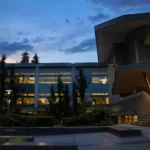 Microsoft campus building at dusk, with lit office windows.