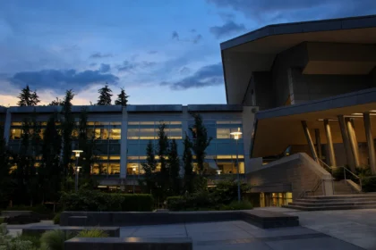 Microsoft campus building at dusk, with lit office windows.