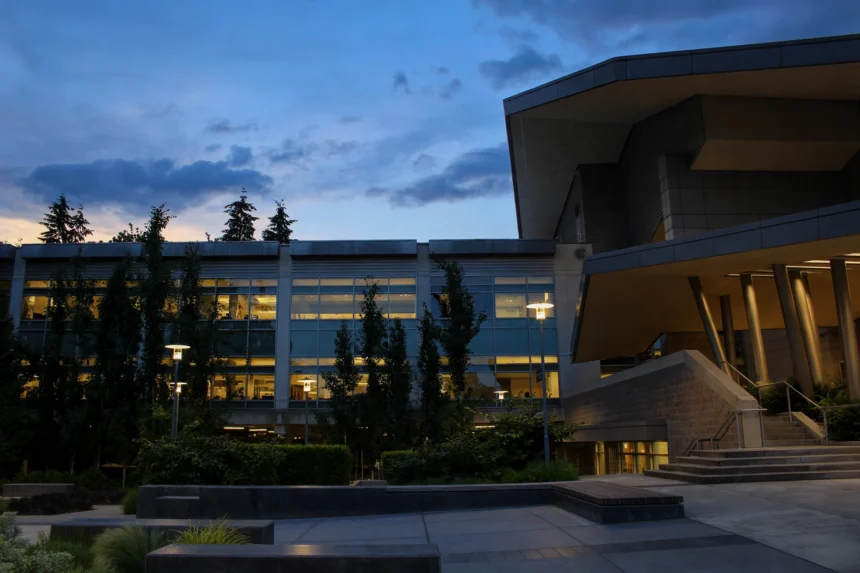 Microsoft campus building at dusk, with lit office windows.
