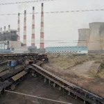 Illustrative view of a large lignite thermal power station with chimneys and cooling towers