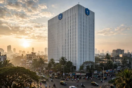 SBI headquarters building in Mumbai. Photo composite: Digamber / Wikimedia Commons (CC0) with AI-generated editorial background.