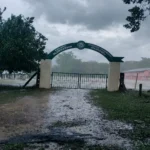 Closed school gate in heavy rain during Cyclone Arnab.