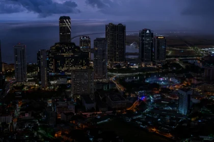 Colombo skyline at dusk. Skyline photo: Thilina Alagiyawanna / Wikimedia Commons (CC0), composite.