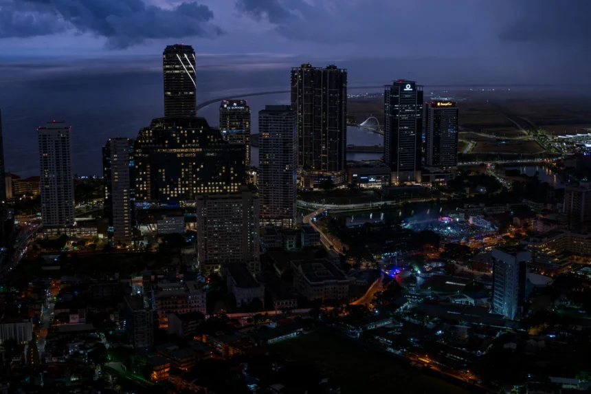 Colombo skyline at dusk. Skyline photo: Thilina Alagiyawanna / Wikimedia Commons (CC0), composite.
