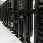 Rows of data centre server racks and fibre patch panels