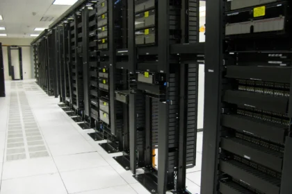 Rows of data centre server racks and fibre patch panels