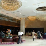 Busy Indian hotel lobby with guests at the front desk
