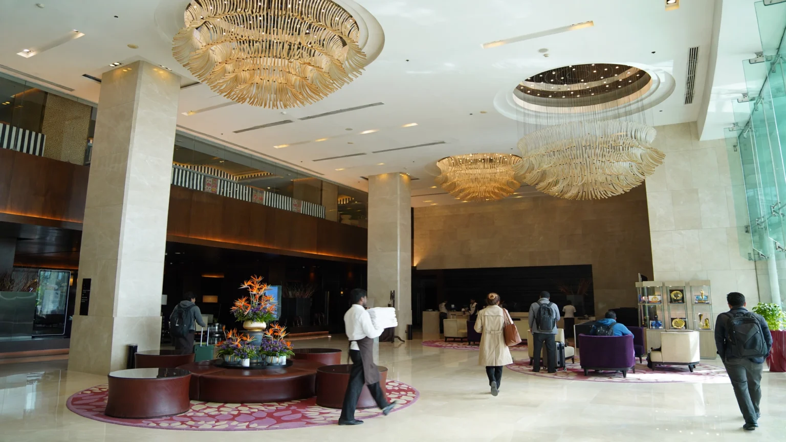 Busy Indian hotel lobby with guests at the front desk