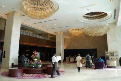 Busy Indian hotel lobby with guests at the front desk
