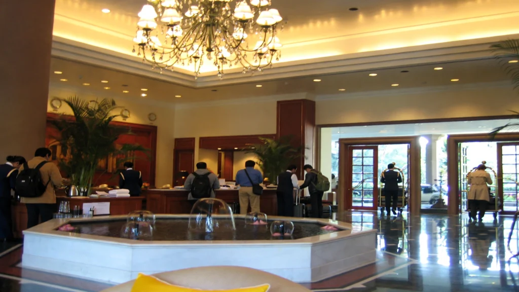 Busy Indian hotel lobby with guests at the front desk