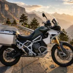 2027 Triumph Tiger 1200 adventure motorcycle on a mountain highway.