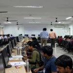 Candidates at computers in a computer lab during a computer-based exam
