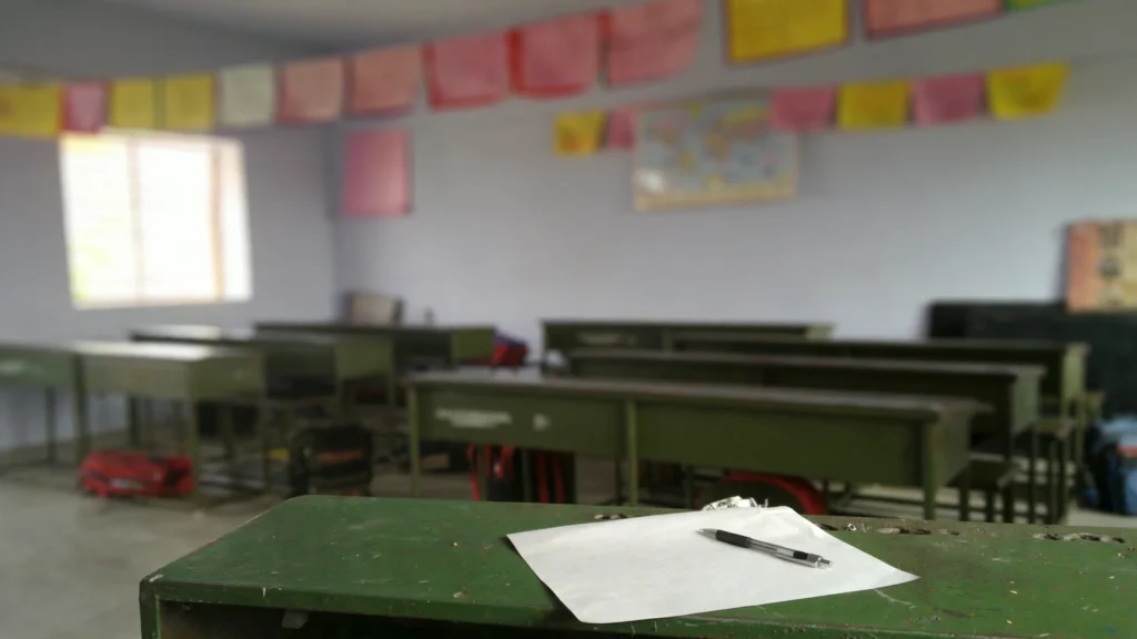 Answer sheet and pen on a classroom desk