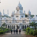 King George's Medical University building in Lucknow, with students walking toward the entrance