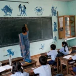 Government primary school classroom in India, teacher at the blackboard.