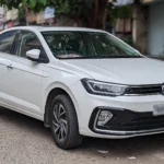 Volkswagen Virtus sedan parked on an Indian city street.
