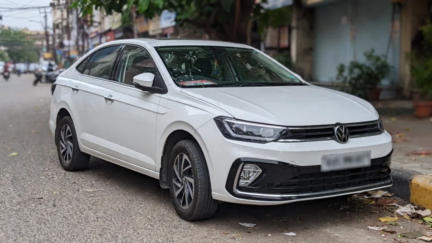 Volkswagen Virtus sedan parked on an Indian city street.
